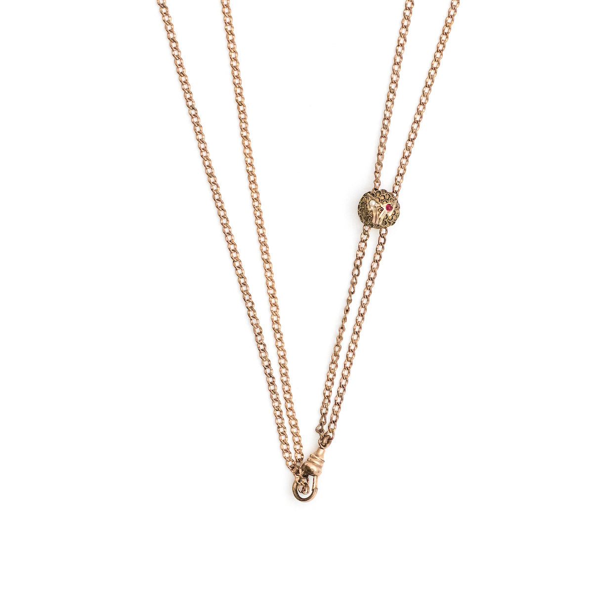This 12K gold fill antique cable chain measures 24" in length doubled and features a swivel clasp and delicate slide adornment. The slide features two arrows, one containing a white stone and one a red. Doubled up, this chain is striking with a gold locket or on its own. Close up view showing arrow slide