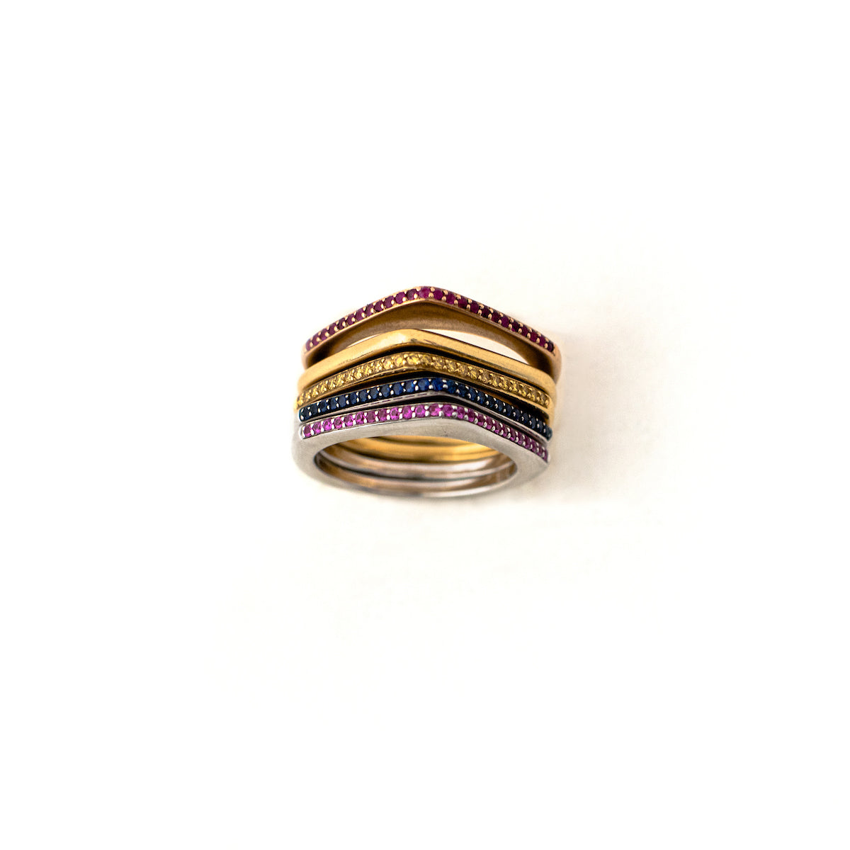 These incredibly unique rings from the 1970s are made of 18K gold and feature a sleek silhouette with a point on the top. They are available either solid gold or encrusted in sapphires. These can be worn on their own, as a set or add one to your existing stack for even more drama. These are a true statement piece! Front ring stack view