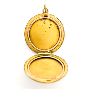 This joyous round locket features an intricate chandelier pattern with white paste stones scattered throughout the design. It opens to hold two photos, includes both original frames and pairs perfectly with one of our antique gold fill chains.  Open locket view