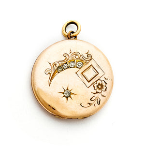 This glossy round locket features a classic Victorian era symbol, the crescent moon and starburst, but with exciting additional accents and flourishes including a forget-me-not flower. It opens to hold two photos, includes both original frames and pairs perfectly with one of our antique gold fill chains.  Front locket view