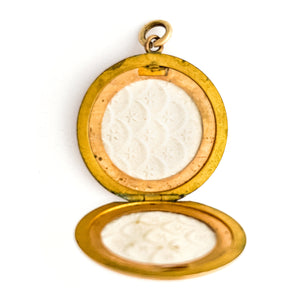 This glossy round locket features a classic Victorian era symbol, the crescent moon and starburst, but with exciting additional accents and flourishes including a forget-me-not flower. It opens to hold two photos, includes both original frames and pairs perfectly with one of our antique gold fill chains.  Open locket view