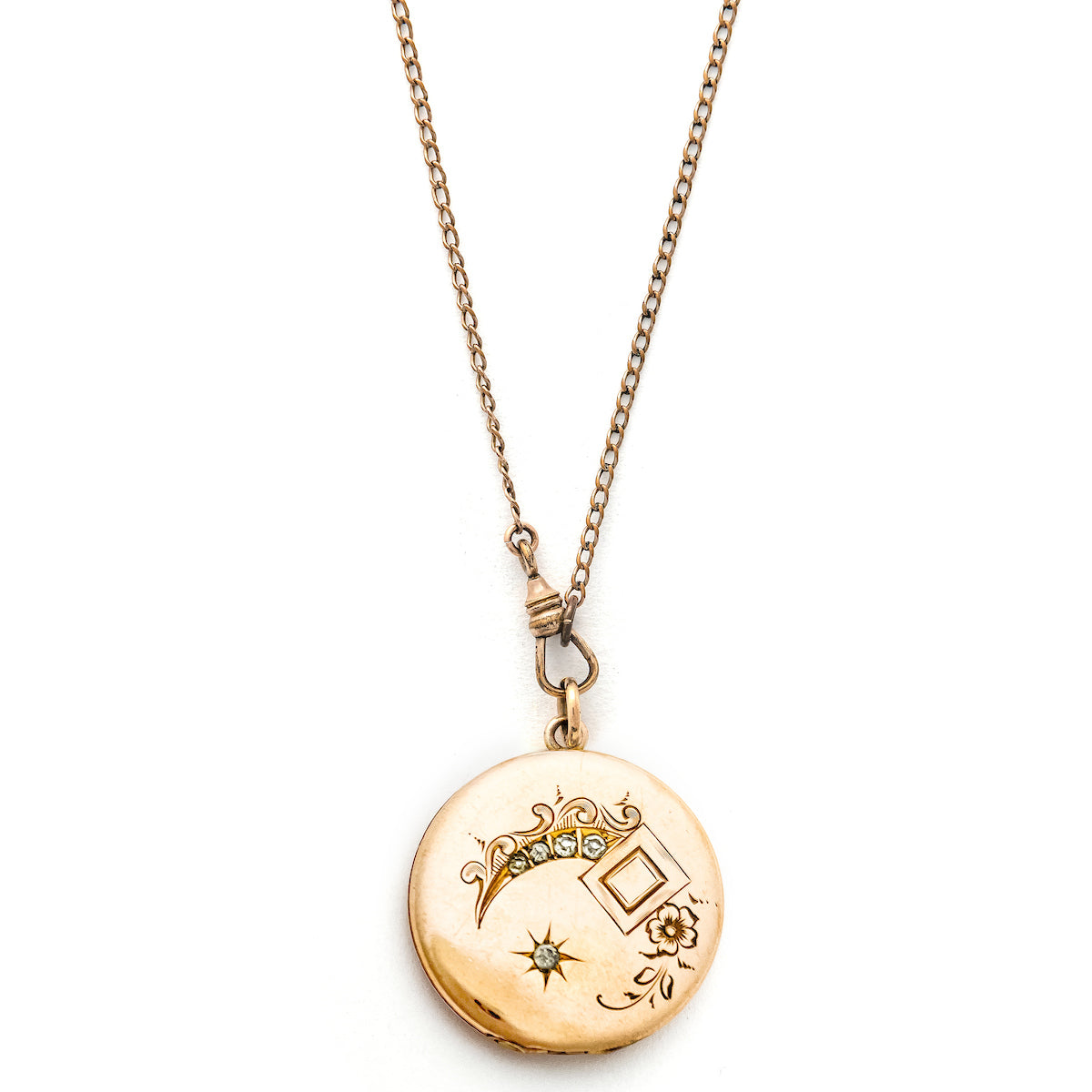 This glossy round locket features a classic Victorian era symbol, the crescent moon and starburst, but with exciting additional accents and flourishes including a forget-me-not flower. It opens to hold two photos, includes both original frames and pairs perfectly with one of our antique gold fill chains.  Front locket view