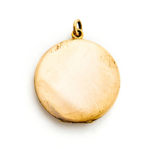 This glossy round locket features a classic Victorian era symbol, the crescent moon and starburst, but with exciting additional accents and flourishes including a forget-me-not flower. It opens to hold two photos, includes both original frames and pairs perfectly with one of our antique gold fill chains.  Locket back view