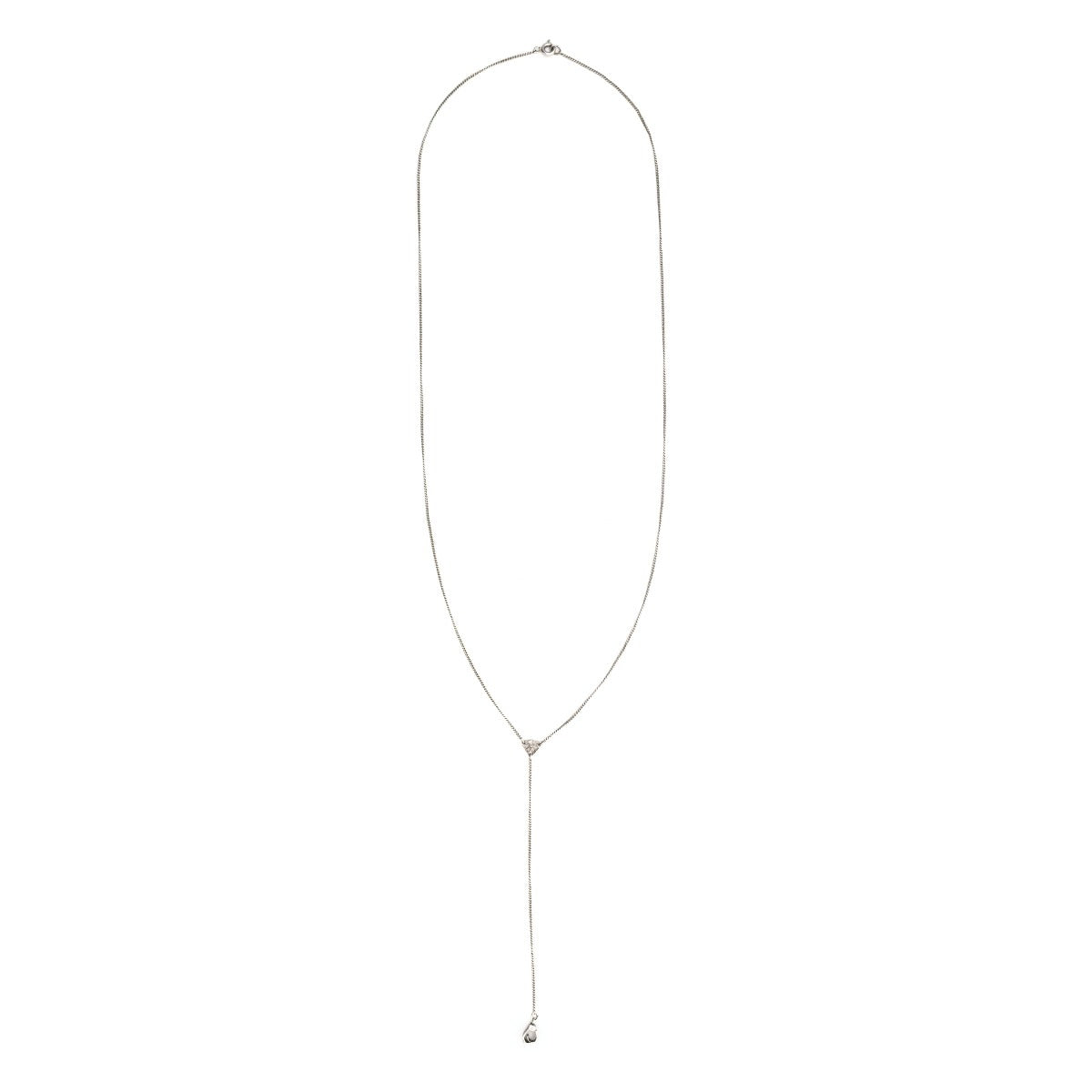 This art deco lorgnette chain measures 24" in length with a 4.5" extension. It features an extremely delicate curb link and an ornamental triangle at the base of the extension. In the Victorian era, lorgnettes carried eyeglasses, but we think it pairs beautifully with one of our vintage lockets or charms. Close up view,