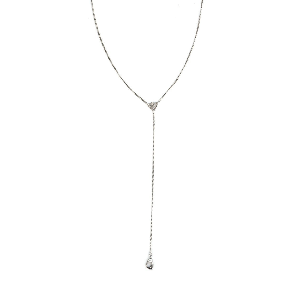 This art deco lorgnette chain measures 24" in length with a 4.5" extension. It features an extremely delicate curb link and an ornamental triangle at the base of the extension. In the Victorian era, lorgnettes carried eyeglasses, but we think it pairs beautifully with one of our vintage lockets or charms. Close up view,