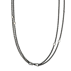 This long Victorian gunmetal chain measures 52" in length and features 10 incredibly cut glass stones. Doubled up on a watch chain clasp, it is nearly 26" in length and is unique on its own or pairs perfectly with one of our vintage lockets. Close up view