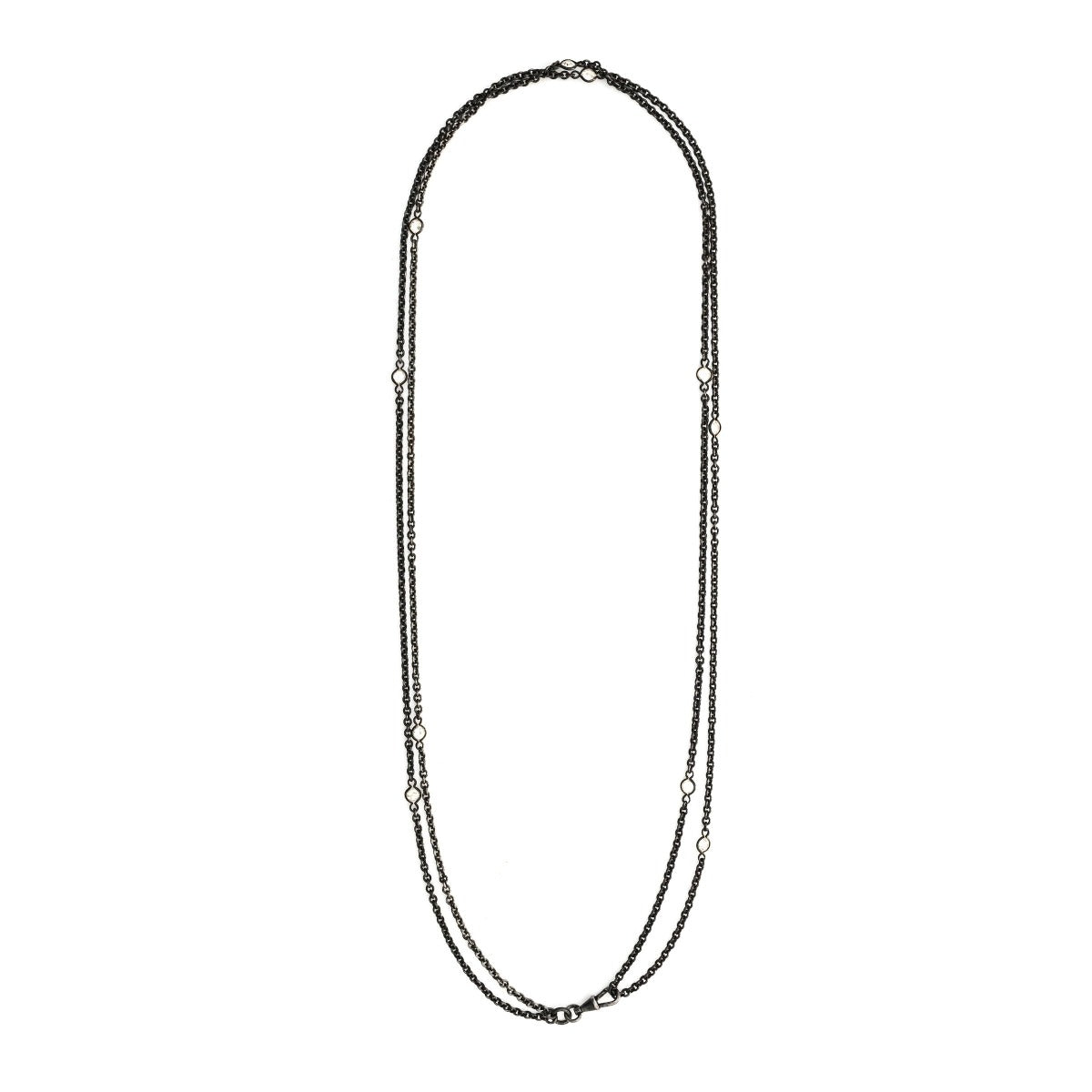 This long Victorian gunmetal chain measures 52" in length and features 10 incredibly cut glass stones. Doubled up on a watch chain clasp, it is nearly 26" in length and is unique on its own or pairs perfectly with one of our vintage lockets. Full chain view