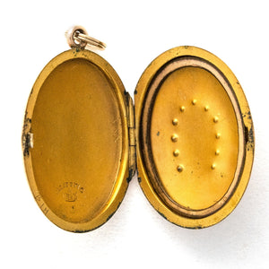 Oval horseshoe antique locket open view, shows original frame, locket holds pictures and photos