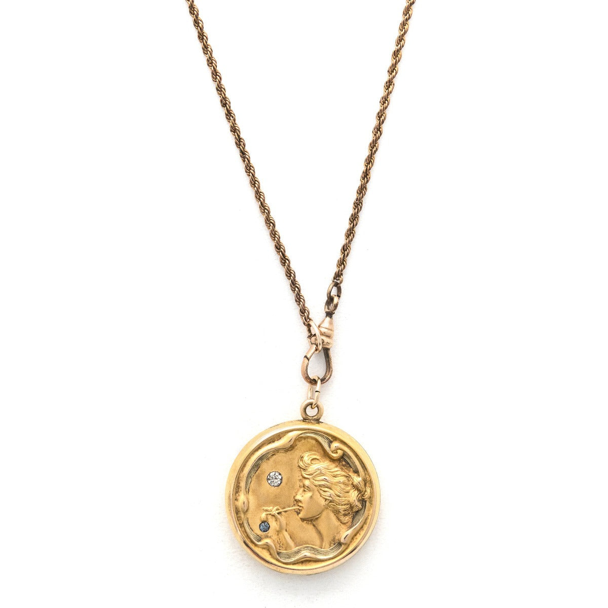 Bubble Fairy antique locket, front view, gold fill, paste stones, woman blowing bubbles, front view