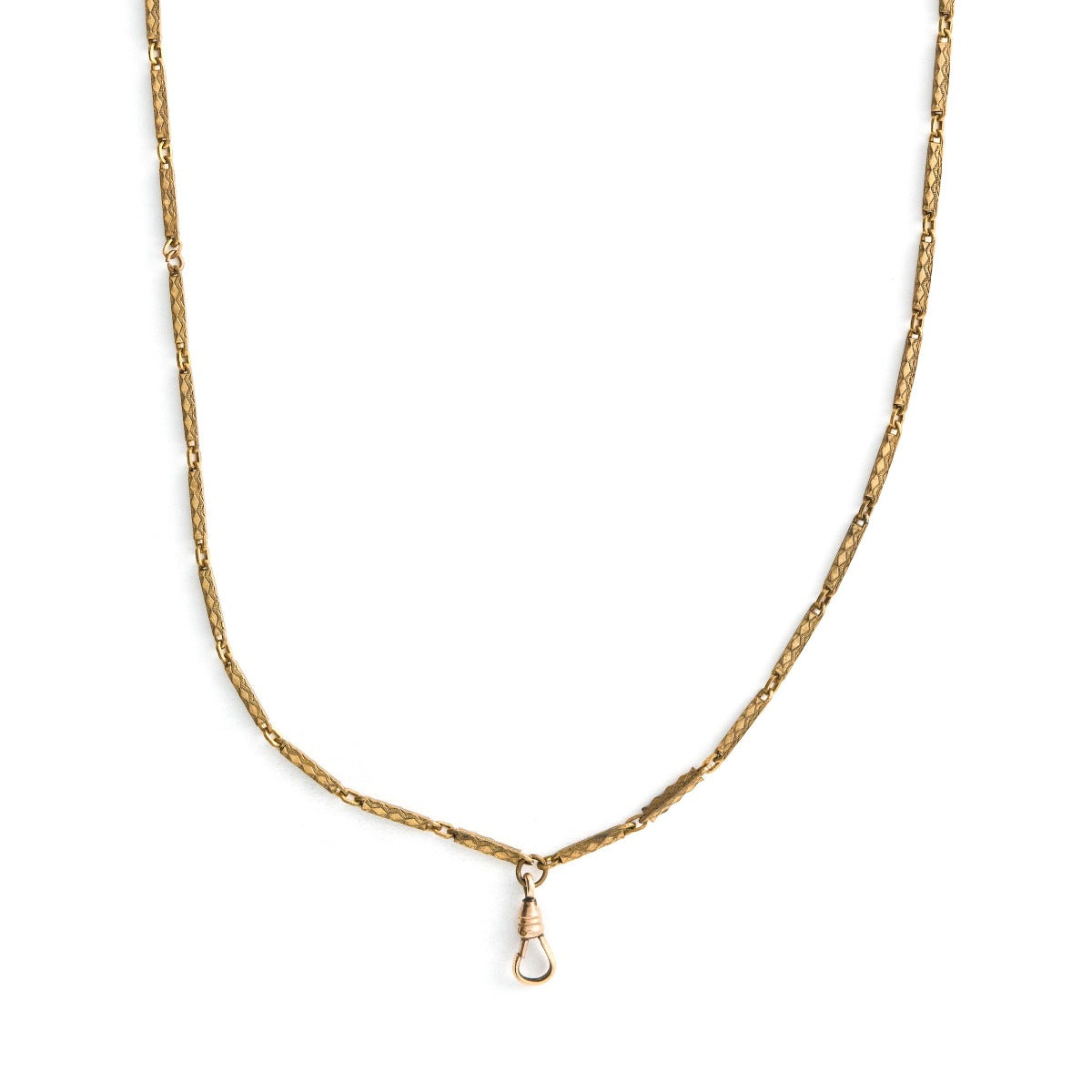 This stunning 28" gold fill bar link chain is made up of substantial bar links, each intricately etched with a zigzag design. The swivel clasp is perfect for a collection of charms or paired with one of our antique lockets.  Close up view showing watch chain clasp