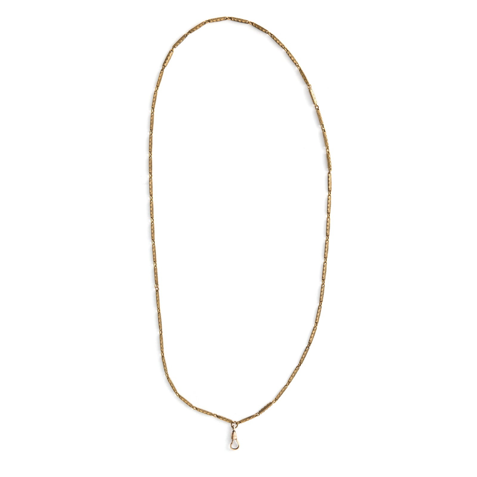 This stunning 28" gold fill bar link chain is made up of substantial bar links, each intricately etched with a zigzag design. The swivel clasp is perfect for a collection of charms or paired with one of our antique lockets.  Close up view showing watch chain clasp
