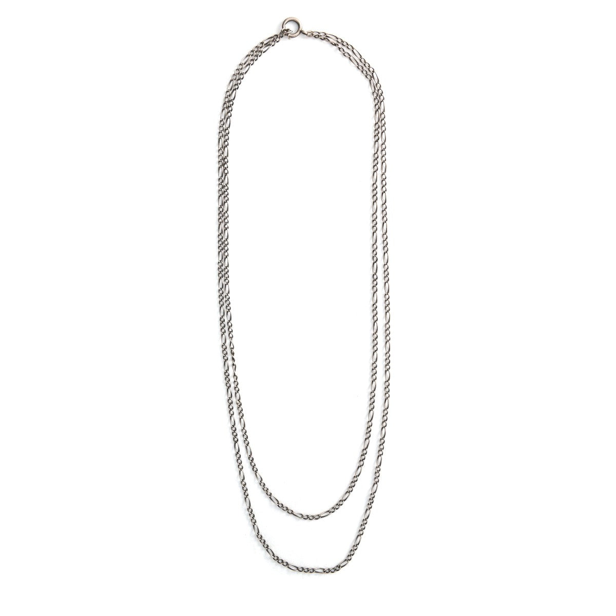 This vintage silver chain measures 52" in length and features figaro links and a spring ring clasp. This chain pairs perfectly with one of our vintage lockets or pendants and can be worn on it's own doubled or long and layered. Close up view