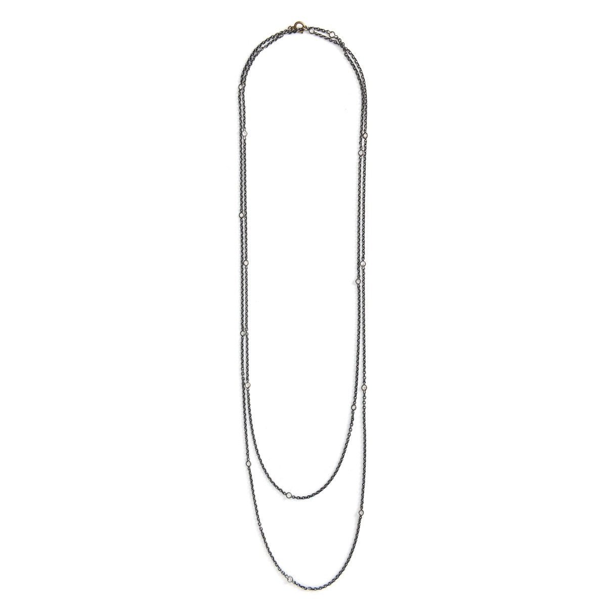 This long Victorian gunmetal chain measures 60" in length and features 18 incredibly cut glass stones. Doubled up on a spring ring clasp, it is nearly 30" in length and is unique on its own or pairs perfectly with one of our vintage lockets or pendants. Close up view showing stones
