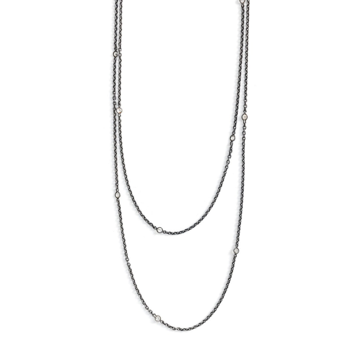 This long Victorian gunmetal chain measures 60" in length and features 18 incredibly cut glass stones. Doubled up on a spring ring clasp, it is nearly 30" in length and is unique on its own or pairs perfectly with one of our vintage lockets or pendants. Close up view showing stones