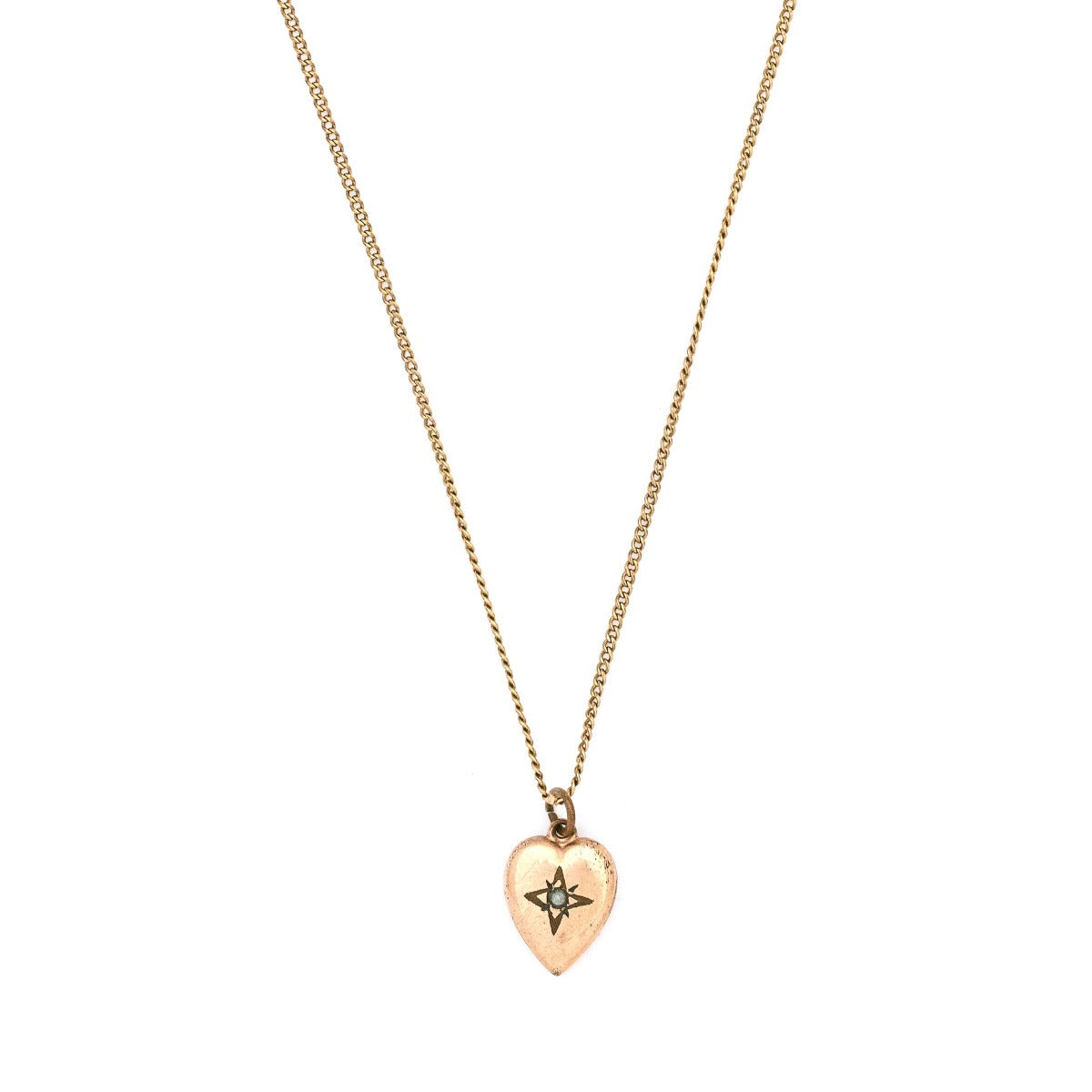 This petite heart shaped Victorian charm features a delicately etched starburst with a seed pearl at it's center. This classic charms pairs perfectly with one of our antique chains. Front charm view, shown on chain
