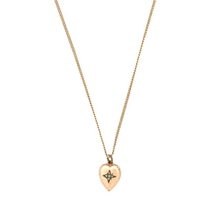 This petite heart shaped Victorian charm features a delicately etched starburst with a seed pearl at it's center. This classic charms pairs perfectly with one of our antique chains. Front charm view, shown on chain