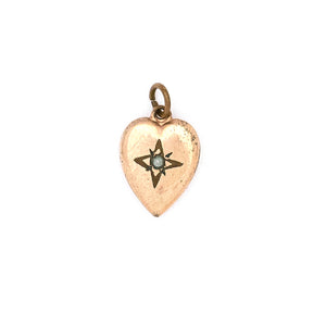 This petite heart shaped Victorian charm features a delicately etched starburst with a seed pearl at it's center. This classic charms pairs perfectly with one of our antique chains. Front charm view