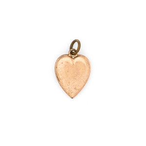 This petite heart shaped Victorian charm features a delicately etched starburst with a seed pearl at it's center. This classic charms pairs perfectly with one of our antique chains. Back charm view