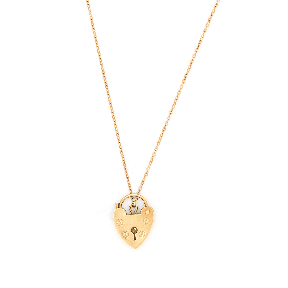 This functioning heart lock charm is made of 9K gold and features a keyhole on the front and a working hinge at the top. The English hallmarks tell us this piece is from London, in 1960. Paired with one of our antique gold chains, this charm can be worn both as a pendant or in a cluster of charms.  Front locket view, shown on chain