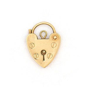 This functioning heart lock charm is made of 9K gold and features a keyhole on the front and a working hinge at the top. The English hallmarks tell us this piece is from London, in 1960. Paired with one of our antique gold chains, this charm can be worn both as a pendant or in a cluster of charms.  Front locket view