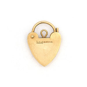 This functioning heart lock charm is made of 9K gold and features a keyhole on the front and a working hinge at the top. The English hallmarks tell us this piece is from London, in 1960. Paired with one of our antique gold chains, this charm can be worn both as a pendant or in a cluster of charms.  Back locket view