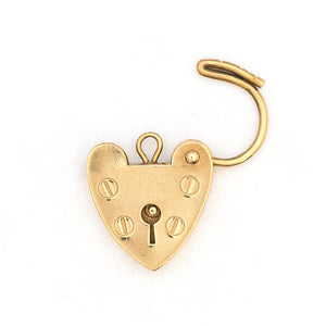 This functioning heart lock charm is made of 9K gold and features a keyhole on the front and a working hinge at the top. The English hallmarks tell us this piece is from London, in 1960. Paired with one of our antique gold chains, this charm can be worn both as a pendant or in a cluster of charms.  Front locket view, shown open