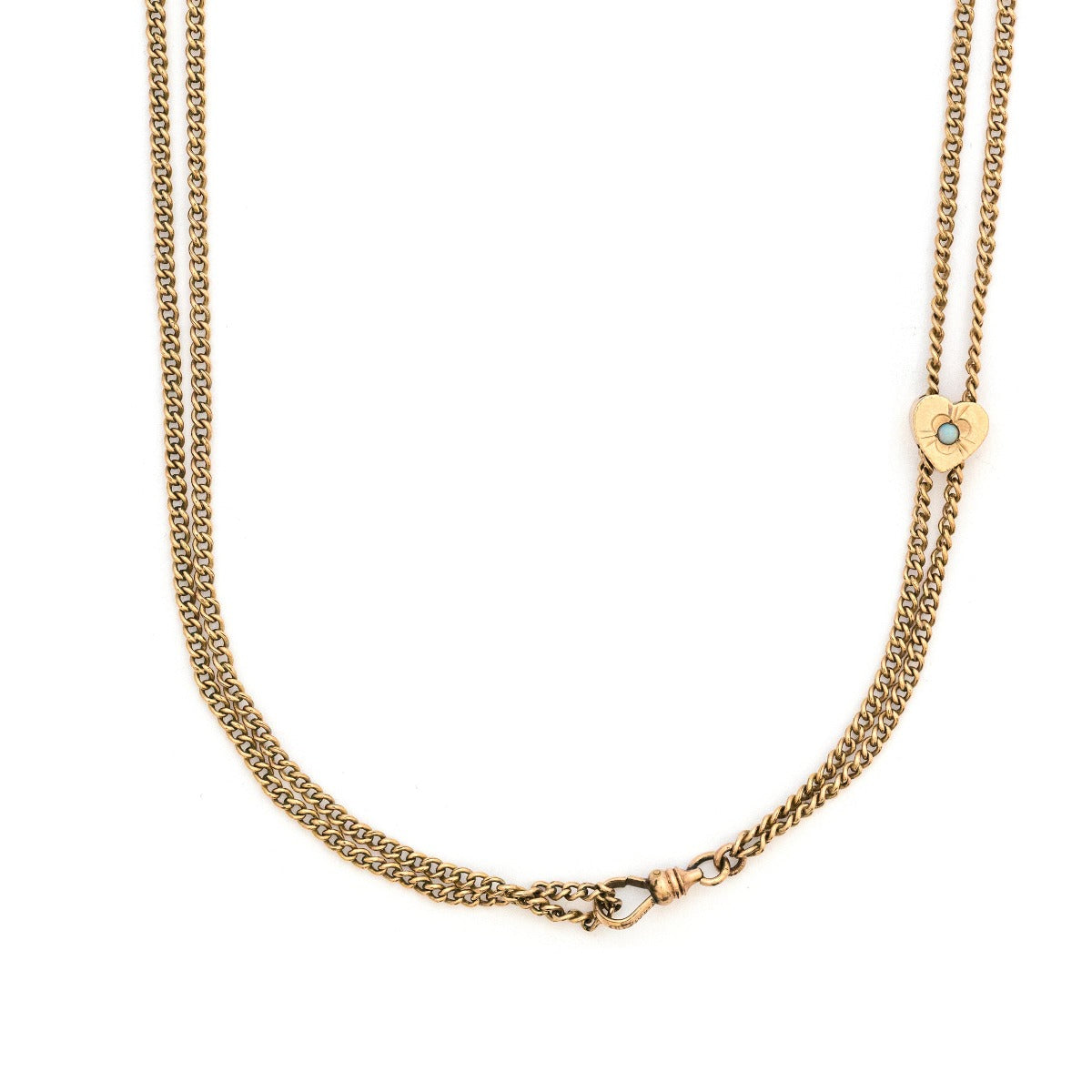 This 12K gold fill antique curb watch chain measures 25" in length doubled.  It features a gold fill heart shaped slide adornment with an etched flower with  an opal at its center. Doubled up, this chain is striking with a gold locket or on its own. Close up view showing heart opal slide