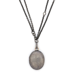 Checkered Oval Niello Antique Locket, black and white checker board locket, for holding pictures and photos, front view, shown on antique gunmetal and glass watch chain
