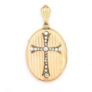 This oval locket features a white paste stone encrusted cross with a pinstripe backdrop. The letter EM are inscribed on the back. It opens to hold two photos, includes one original frame and pairs perfectly with one of our antique gold fill chains.  Front Locket view