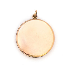 This round Victorian locket features a playful design which uses curlicues and flourishes to enhance the white and red paste stones. It opens to hold two photos, includes both original frames and pairs perfectly with one of our antique gold fill chains.  Back locket view