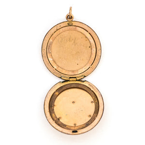 This round Victorian locket features a playful design which uses curlicues and flourishes to enhance the white and red paste stones. It opens to hold two photos, includes both original frames and pairs perfectly with one of our antique gold fill chains.  Open locket view