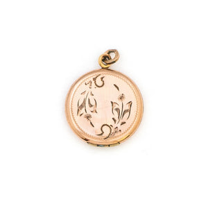 This petite round locket features a playful daisy pattern and a finely etched zigzag design around the border. It opens to hold two photos and pairs perfectly with one of our antique gold fill chains.  From Locket View