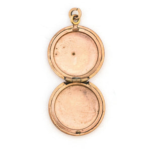 This petite round locket features a playful daisy pattern and a finely etched zigzag design around the border. It opens to hold two photos and pairs perfectly with one of our antique gold fill chains.  Open Locket View