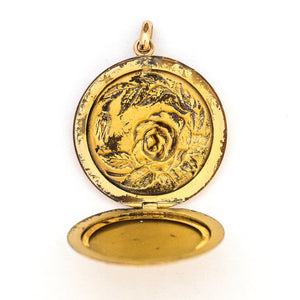 This incredibly detailed round locket features a raised relief rose and branches with three white paste stones throughout the design. The letters JMR are inscribed on the back. It opens to hold two photos, includes one original frame and pairs perfectly with one of our antique gold fill chains.  Open locket view