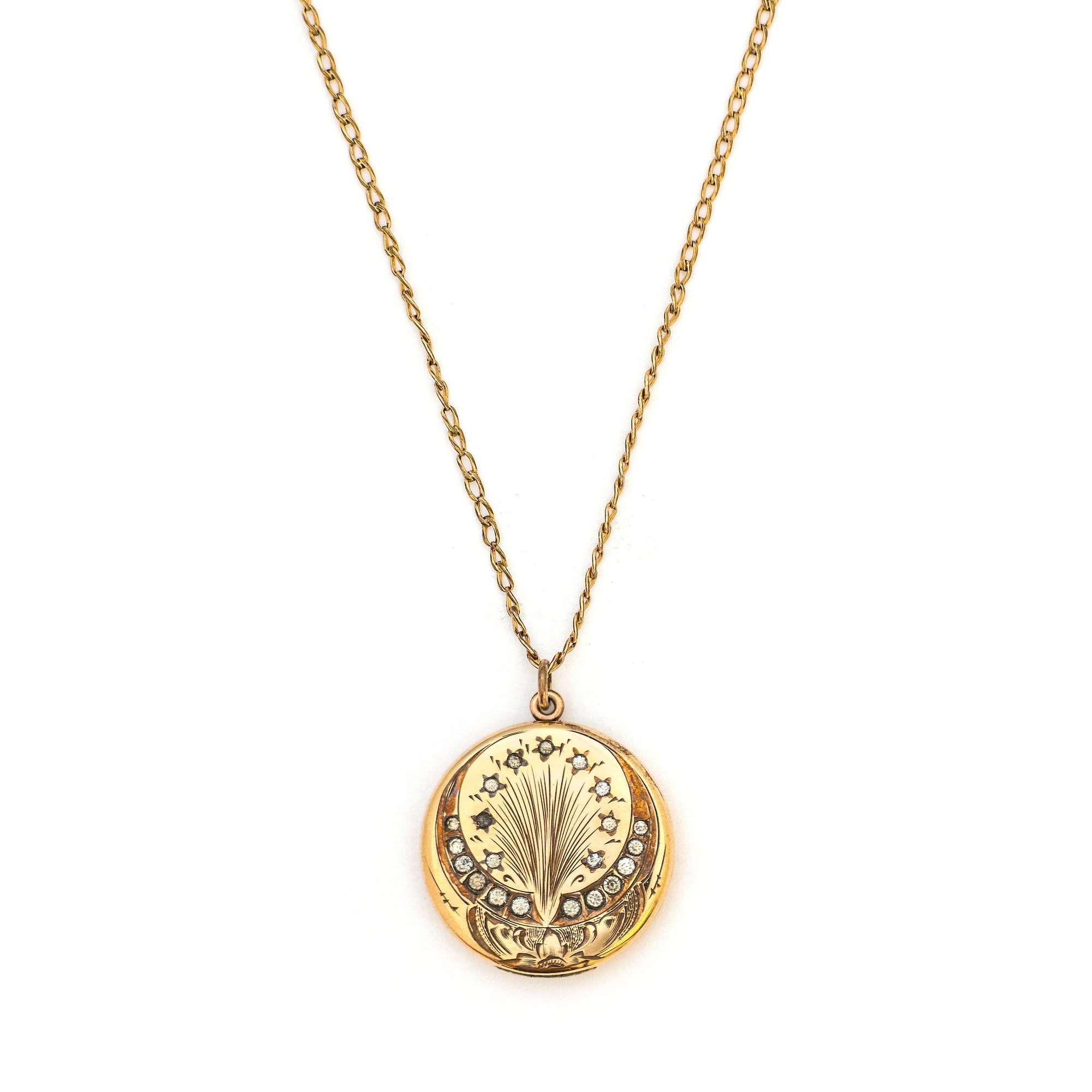 This spirited round locket features an explosive fireworks design enhanced by 21 white Victorian paste stones. It opens to hold two photos, includes both original frames and pairs perfectly with one of our antique gold fill chains.  Front Locket View