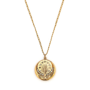 This spirited round locket features an explosive fireworks design enhanced by 21 white Victorian paste stones. It opens to hold two photos, includes both original frames and pairs perfectly with one of our antique gold fill chains.  Front Locket View, shown on chain