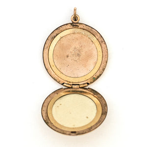 This spirited round locket features an explosive fireworks design enhanced by 21 white Victorian paste stones. It opens to hold two photos, includes both original frames and pairs perfectly with one of our antique gold fill chains.  Open Locket View