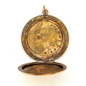 This large round locket features a pearl encrusted crescent moon and a starburst with a 4 mm opal at the center. It opens to hold two photos and pairs perfectly with one of our antique gold fill chains.  Open locket view