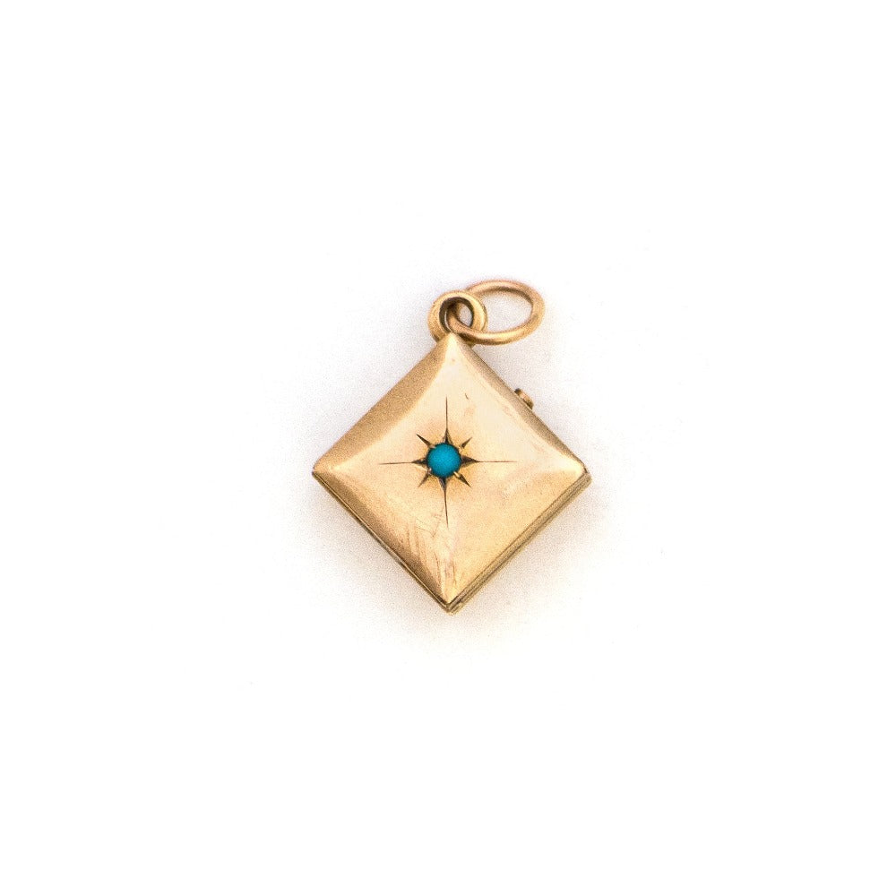 This square 10K gold locket features a simple Victorian starburst with turquoise at it's center and the letter G is inscribed on the back. It opens to hold two photos and pairs perfectly with one of our antique 14K gold chains.  Front Locket View