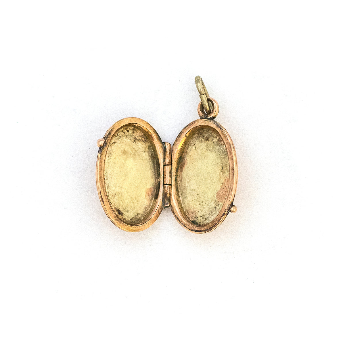 This petite oval 14K gold locket features a classic Victorian sparrow surrounded by carefully etched greenery on the front and back. It opens to hold two photos and pairs perfectly with one of our antique 14K gold chains. Open locket view