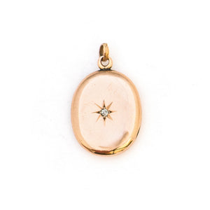 This classic oval 10K gold locket features a simple Victorian starburst with a genuine diamond at it's center and the letters JFD  inscribed on the back. It opens to hold two photos, includes one original frame and pairs perfectly with one of our antique 14K gold chains.  Front Locket View