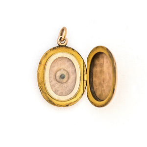 This classic oval 10K gold locket features a simple Victorian starburst with a genuine diamond at it's center and the letters JFD  inscribed on the back. It opens to hold two photos, includes one original frame and pairs perfectly with one of our antique 14K gold chains.  Open Locket View
