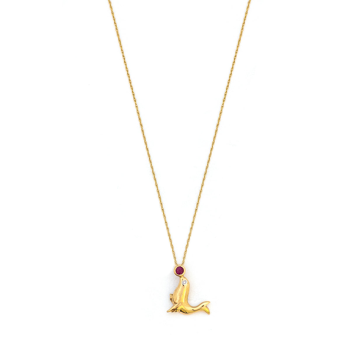 This playful seal charm is made of 10K Gold and features a genuine ruby as the ball on the tip of the seals nose and a diamond as the seal's eye. Paired with one of our antique 14K gold chains, this fun charm can be worn both alone as a pendant or in a cluster of charms. Front charm view