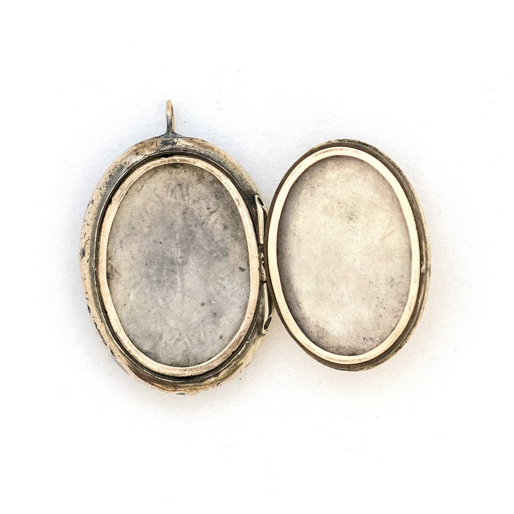 This unusual 10K gold oval locket features extremely intricate Niello technique with use of both yellow and rose gold and silver, a truly unique piece! It opens to hold two photos, includes both original frames and pairs perfectly with one of our antique 14K gold chains.  Open locket view