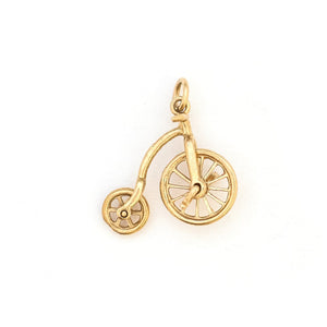 This English bicycle charm is made of 9K Gold. If features working wheels that spin, and an extreme attention to detail. The English gold hallmarks let us know that it was made in London in 1979 by A & Co. Paired with one of our antique 14K gold chains, this fun charm can be worn both alone as a pendant or in a cluster of charms. Front charm view