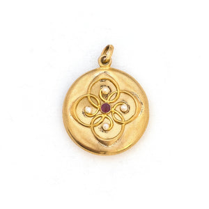 This 14K gold round locket features a raised circular design centered around a beautiful ruby and 4 pearls. The initials FES are intricately inscribed on the back. It opens to hold two photos, includes one original frame and pairs perfectly with one of our antique 14K gold chains.  Front Locket View