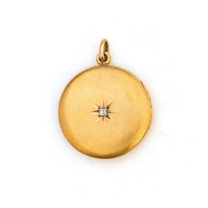 This 10K matte gold locket features a Victorian starburst with a 3 point diamond at its center. The initials MLA are elegantly inscribed on the back. It opens to hold two photos, includes both original frames and pairs perfectly with one of our antique 14K gold chains.  Front Locket View