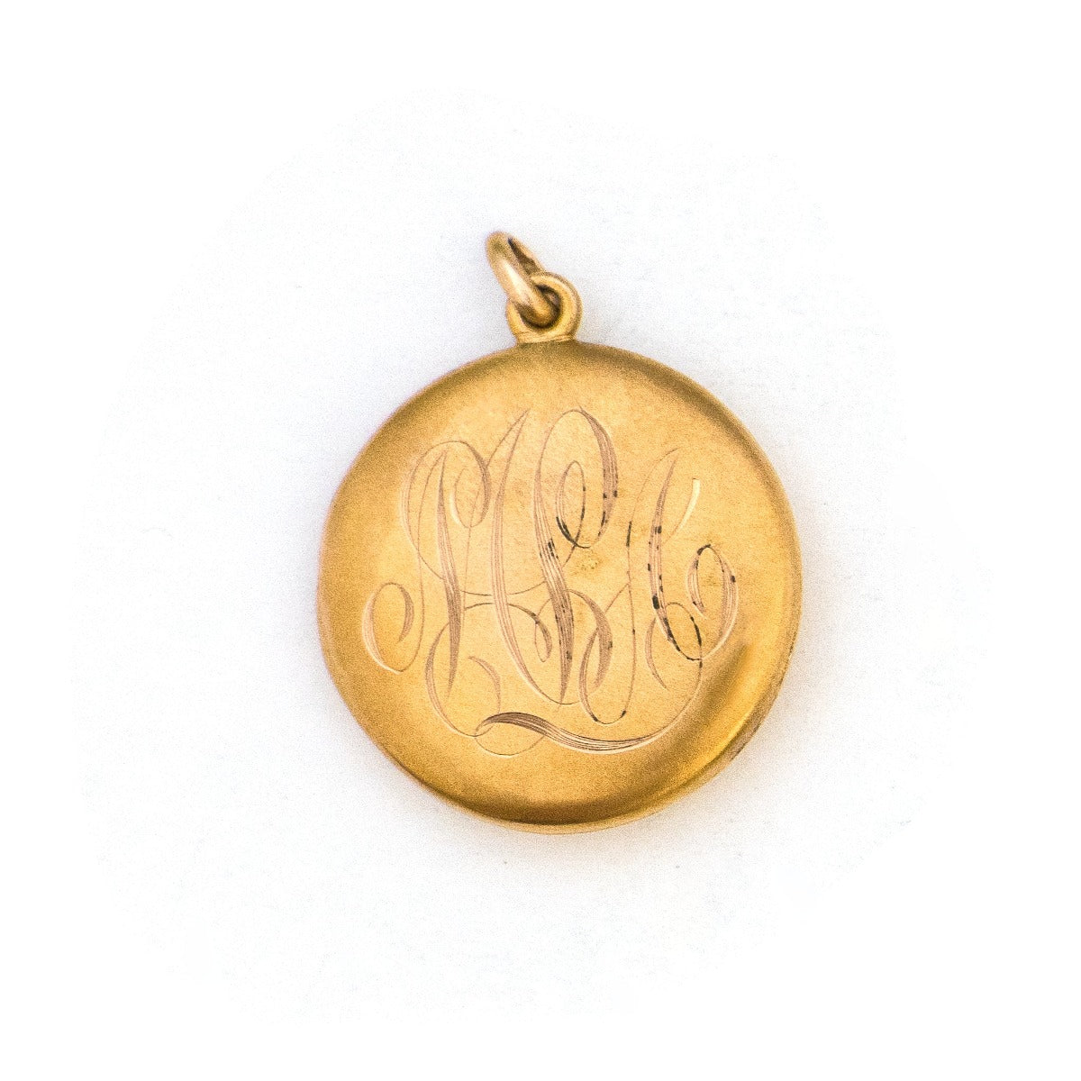 This 10K matte gold locket features a Victorian starburst with a 3 point diamond at its center. The initials MLA are elegantly inscribed on the back. It opens to hold two photos, includes both original frames and pairs perfectly with one of our antique 14K gold chains.  Back locket view