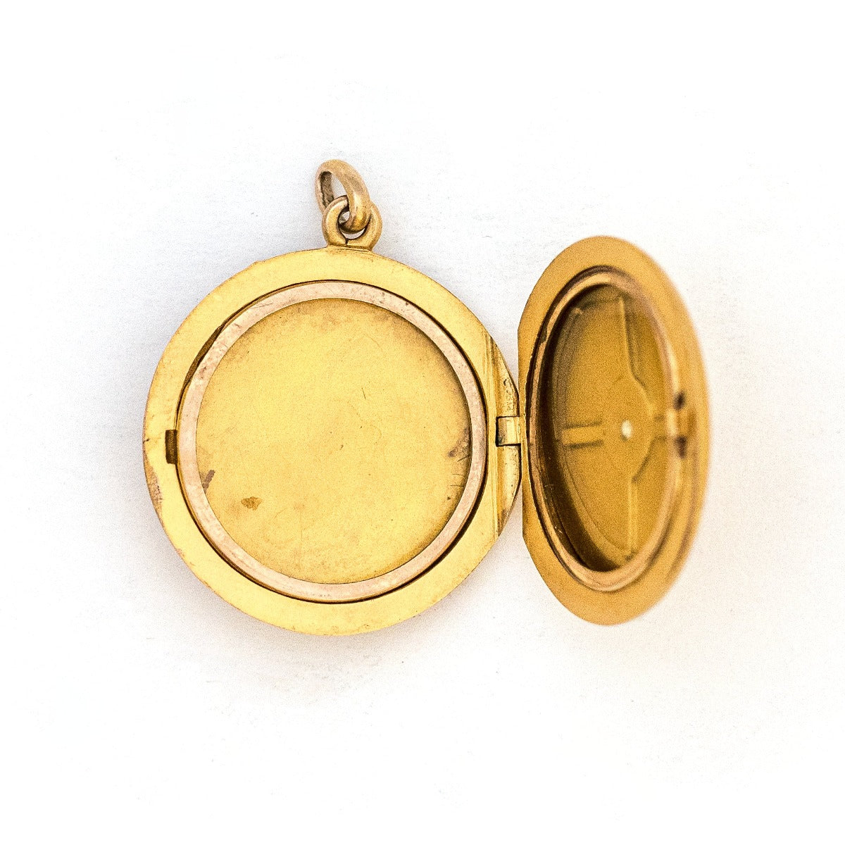 This 10K matte gold locket features a Victorian starburst with a 3 point diamond at its center. The initials MLA are elegantly inscribed on the back. It opens to hold two photos, includes both original frames and pairs perfectly with one of our antique 14K gold chains.  Locket open view