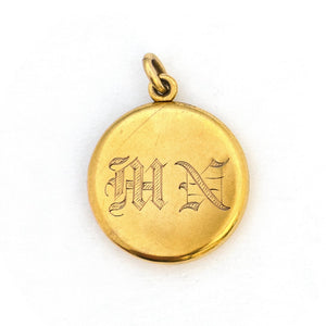 This breathtaking 14K gold locket features a woman in raised relief with her hair swirling around the lockets perimeter and a Victorian starburst with a 3 point diamond at its center. The initials MN are elegantly inscribed on the back. It opens to hold two photos, includes both original frames and pairs perfectly with one of our antique 14K gold chains. Back Locket view